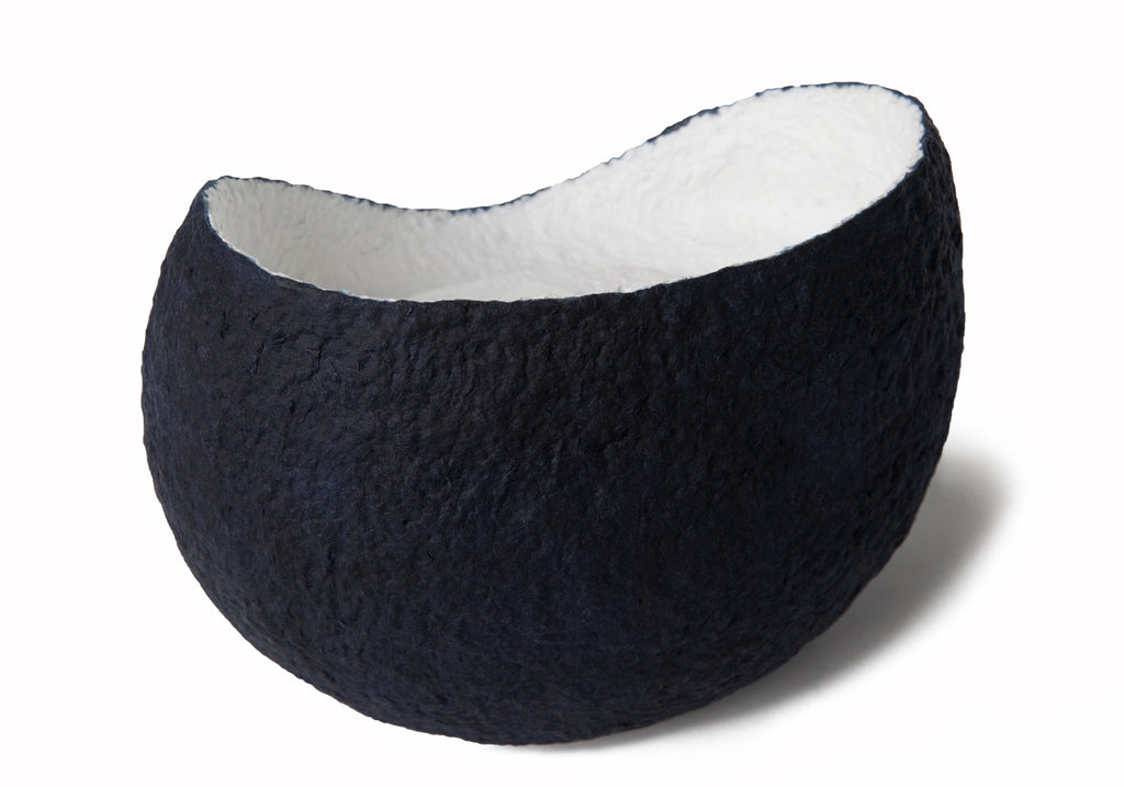 Picture of a white and blue ovoid shaped biodegradable cremation urn for dogs on sale at Muses Design Urns. Left side view.